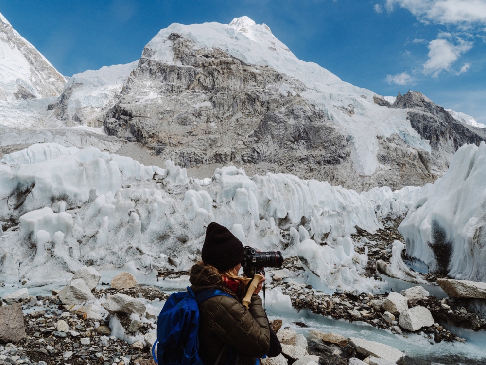 a lady captures photo of khumbu glacier